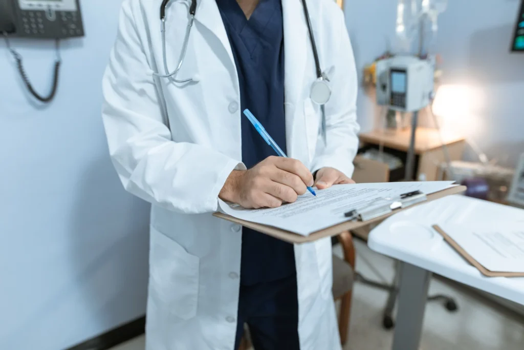 doctor writing on a clipboard notes for a veteran's medical nexus letter