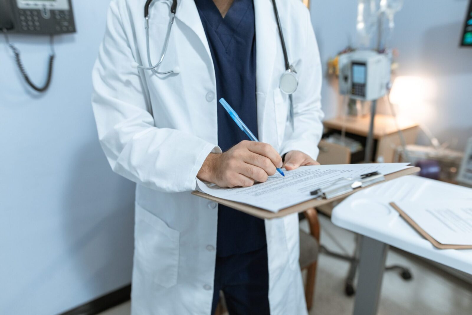 doctor writing on a clipboard