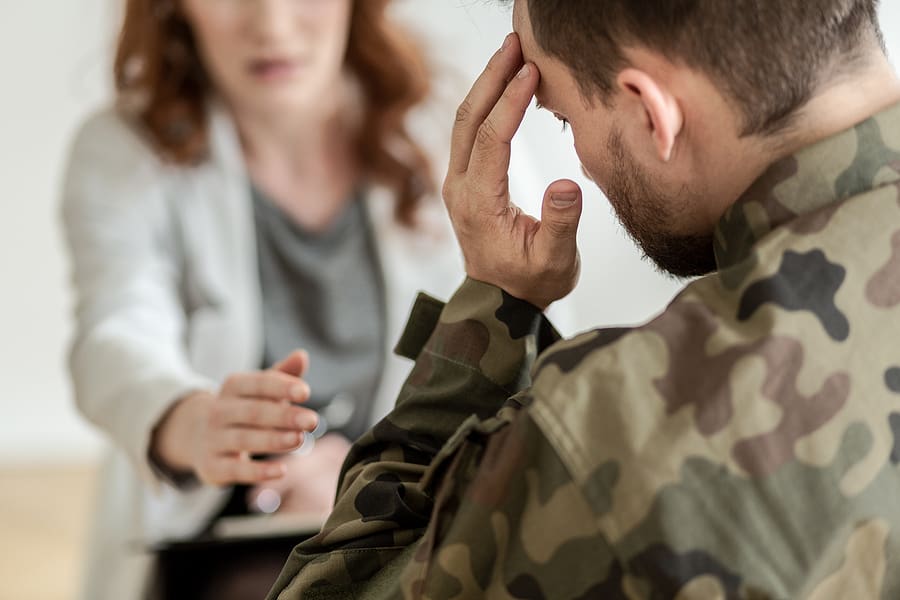 Stressed veteran speaks with a consultant