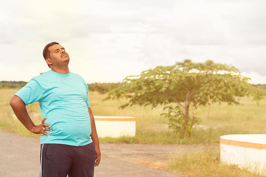 Young overweight veteran taking a break while jogging