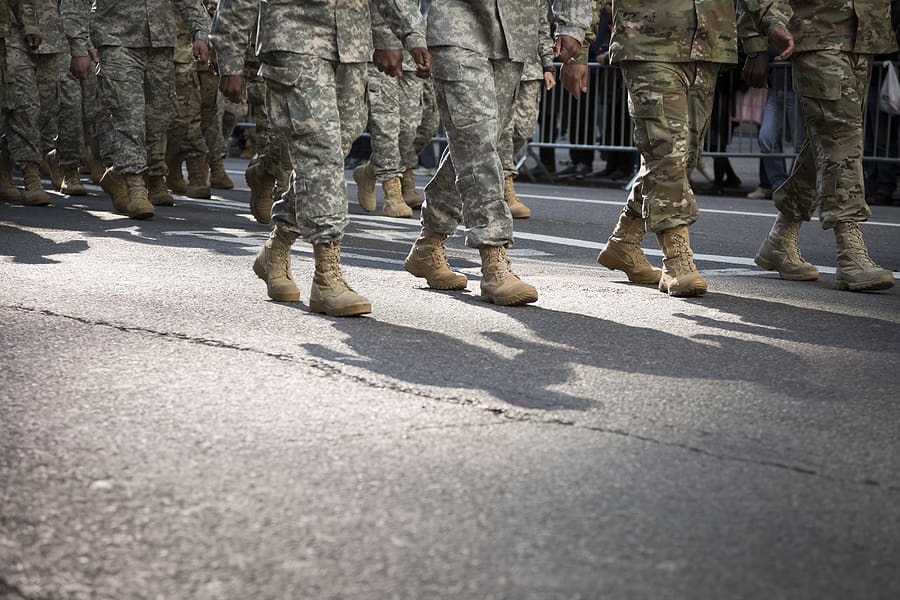 Army personnel marching in parade in uniform