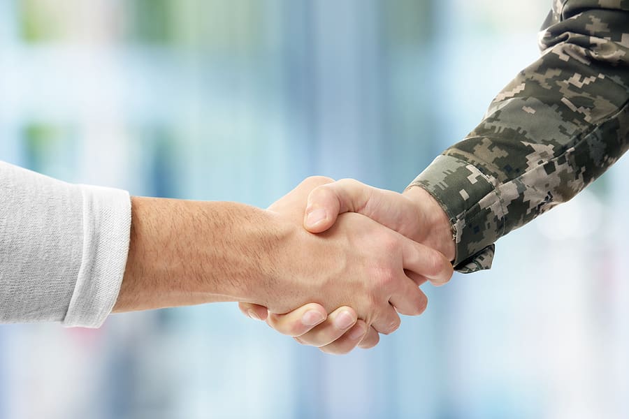 National guard member shakes hands with a civilian