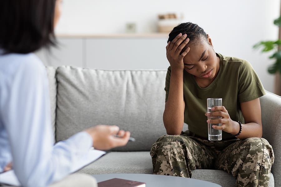 Female military veteran speaking with a therapist after surviving a sexual assault