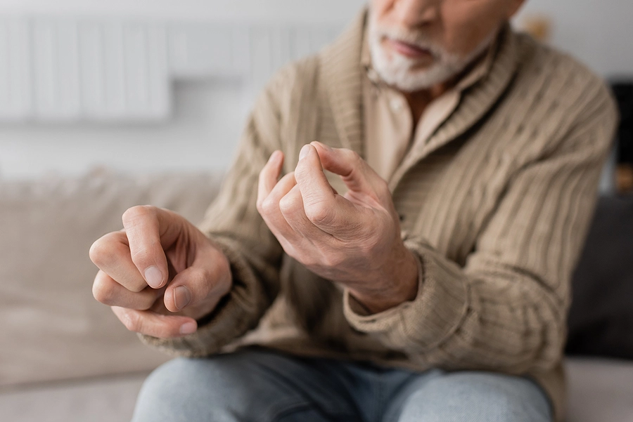 Older male veteran suffering from Agent Orange symptoms in the form of hand tremors