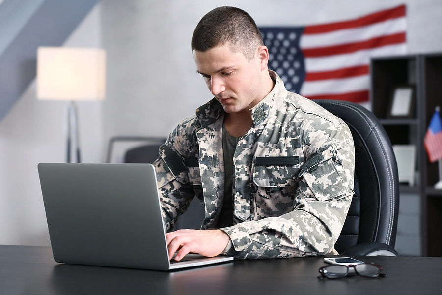 Male veteran researching whether his disability qualifies as a PACT Act presumptive condition on his laptop