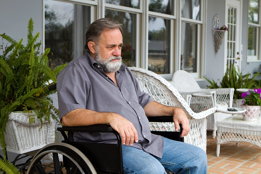 older male veteran with multiple sclerosis sitting in a wheelchair outside