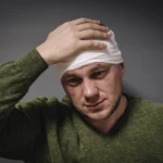 Veteran with service-related disability wearing a head bandage after sustaining a traumatic brain injury