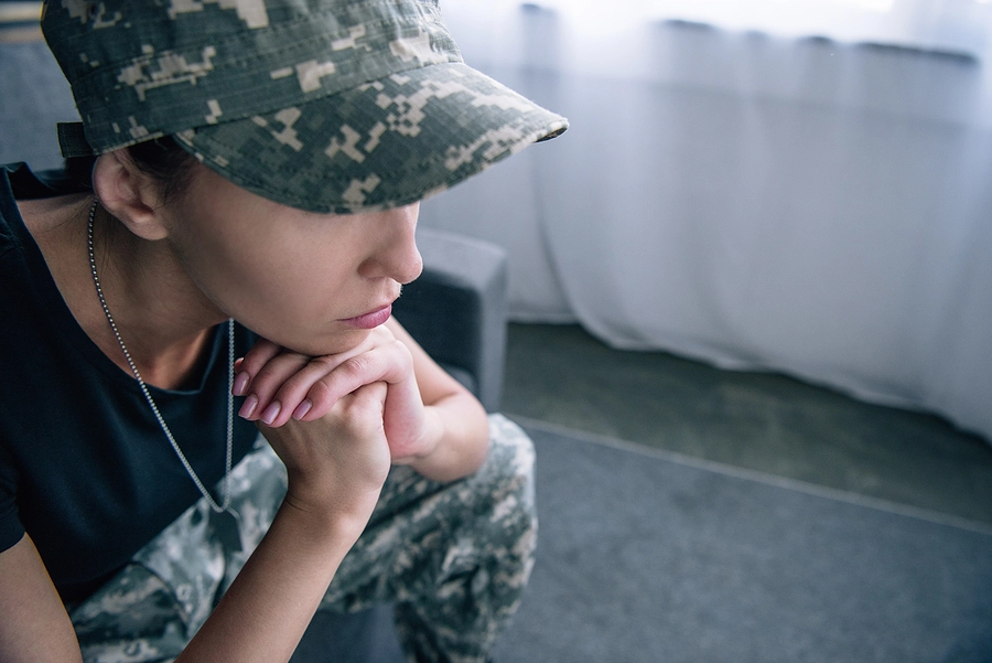 woman in military uniform sitting at home contemplating if she should take her case to the Board of Veterans' Appeals