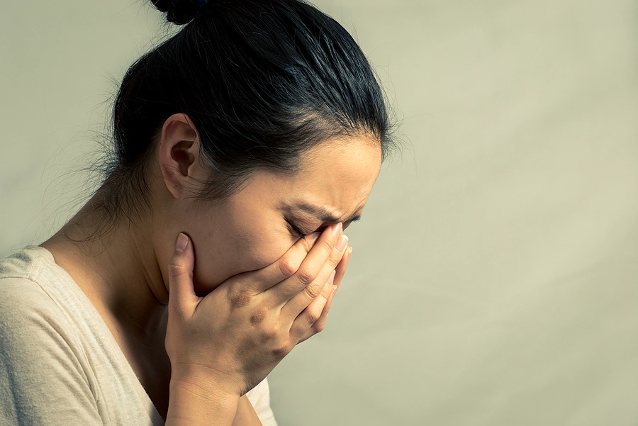 young asian female veteran with depression looking upset